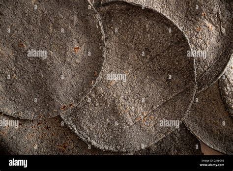 Blue Corn Tortillas. Food made with nixtamalized corn, a staple food in several American ...