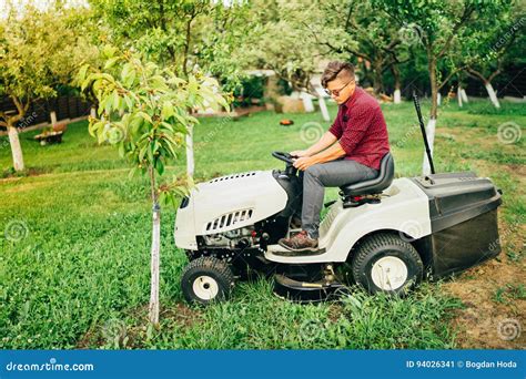 Man Using Lawn Tractor For Mowing Grass. Landscaping Works With ...