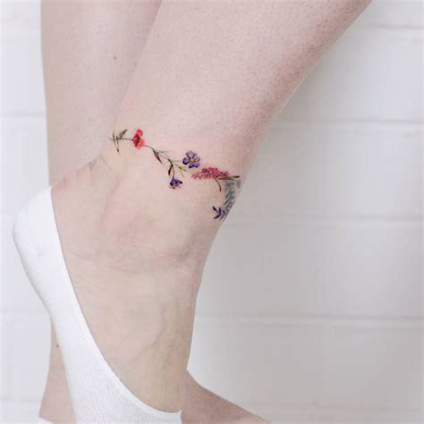 Flower anklet tattoo.