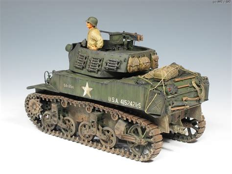 a toy army tank sitting on top of a white table