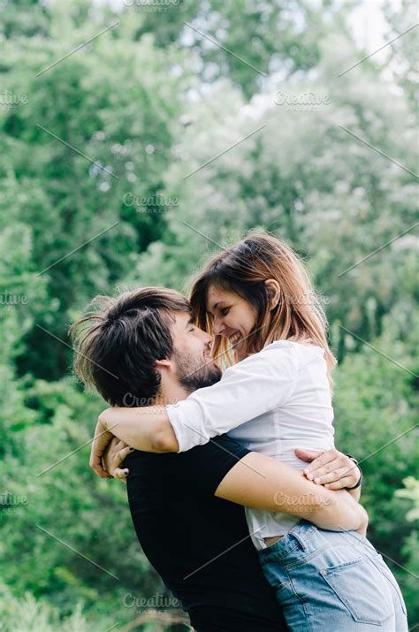 Happy couple kissing and hugging in | High-Quality People Images ~ Creative Market