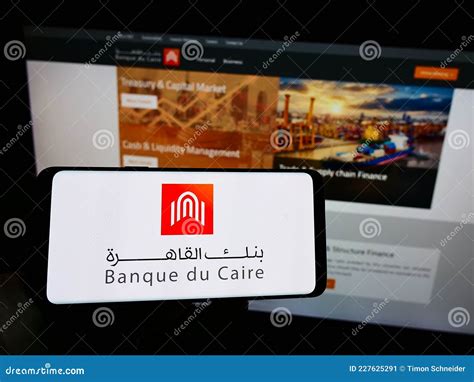 Person Holding Cellphone with Logo of Egyptian Bank Banque Du Caire on ...