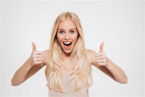 Portrait of a happy excited woman showing thumbs up | Free Photo