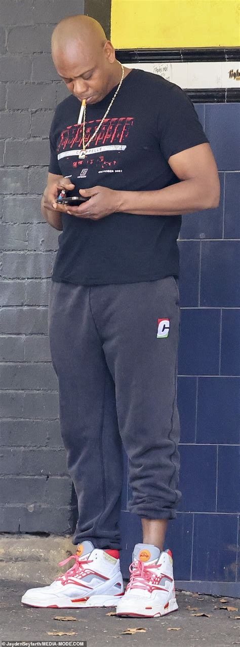 Dave Chappelle cuts a casual figure as he smokes a cigarette in Sydney ...