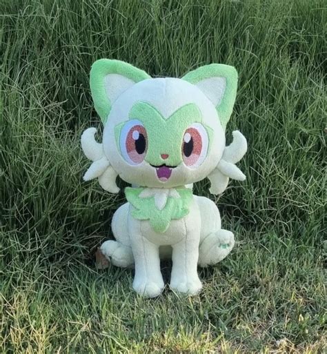 a small stuffed animal sitting in the grass