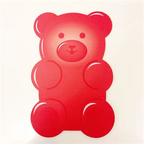 a red teddy bear sticker sitting on top of a white table