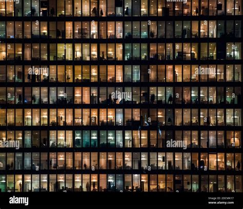 office building facade - business people working at night Stock Photo ...