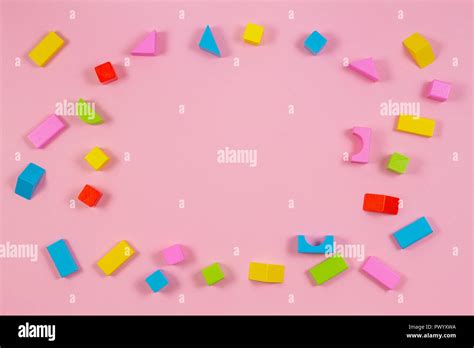 Colorful wooden building blocks on pink background Stock Photo - Alamy