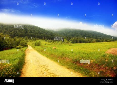 Pathway in foggy mountains hills landscape Bieszczady Poland Stock ...