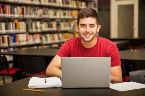 Free Photo | Portrait of an attractive Latin student doing some school work with a laptop in the ...