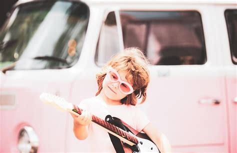 Premium Photo | Child singing and playing guitar outside retro colorful ...