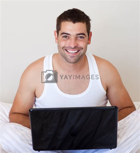 Handsome man using his laptop on the bed by Wavebreakmedia Vectors & Illustrations with ...