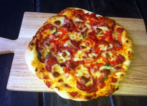 Russell’s Little Secret. Stone Pizza. With Ham, Sopressa, Capsicum, Confit Garlic, Basil and ...