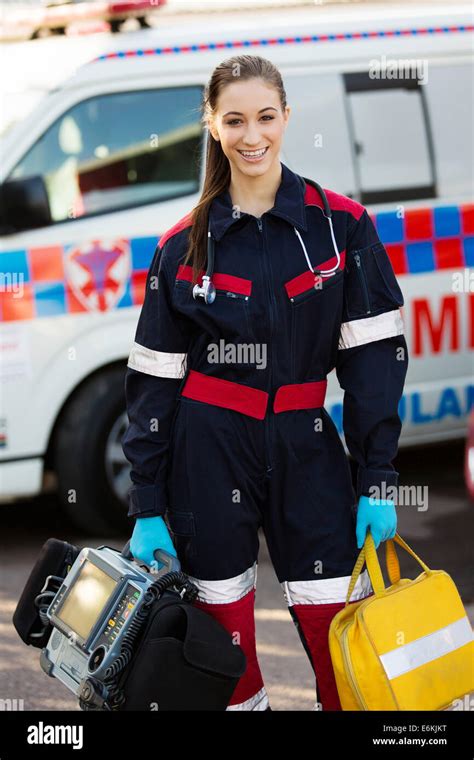 attractive female paramedic holding portable devices Stock Photo - Alamy