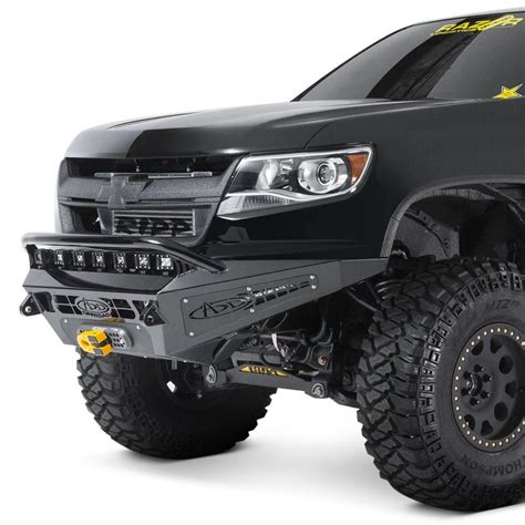 the front end of a black truck with yellow stars on it's bumpers