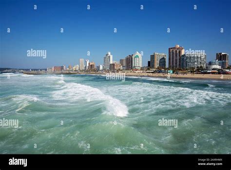 Surf on the Northbeach in front of the towers of Durban Stock Photo - Alamy