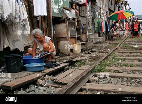 Laundry by the railway tracks in Manila slums, Philippines Stock Photo ...