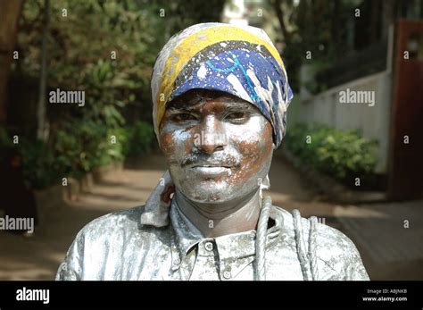 PKB78869 Indian roadside lamp post painter with silver color India Stock Photo - Alamy