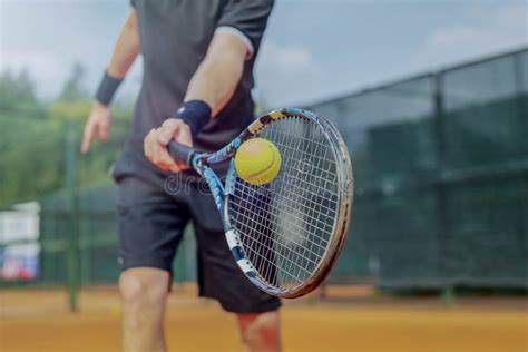 Close Up of Man Playing Tennis at Court and Beating the Ball with a ...