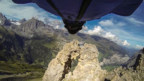 An Insane Wingsuit Flight Through a Tiny Two-Meter Opening Between Rock ...