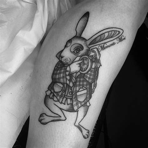 a black and white photo of a rabbit tattoo