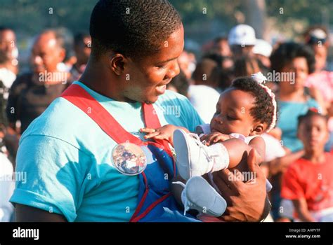 African American father holding his baby at Black Fatherhood event Los ...