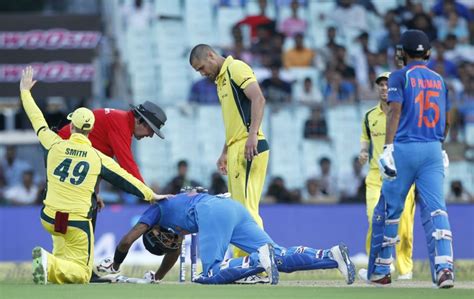 The Australia players check on Hardik Pandya after he was hit ...