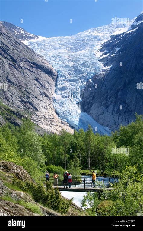 Tourists walking to Briksdalbreen glacier Briksdal near Olden Stryn Sogn og Fjordane Norway ...