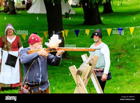 Man in medieval costume, firing harquebus, arquebus, early reconstructed gun, circa 16th century ...