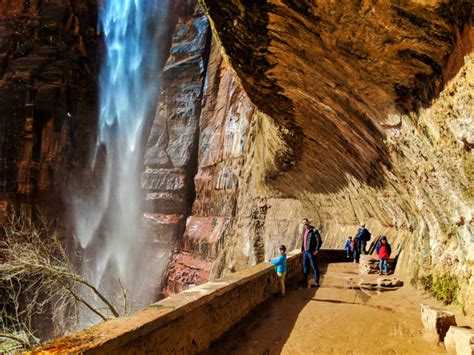 Taylor Family behind waterfall at Weeping Wall trail Zion National Park ...