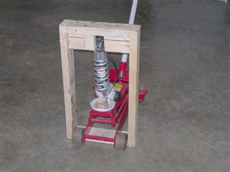 Spring Compressor by Stromboli -- Homemade spring compressor constructed from lumber and a floor ...