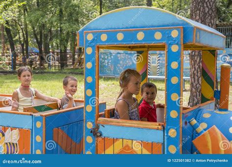 Four Little Children are Riding on a Children& X27;s Train in the Park Stock Photo - Image of ...