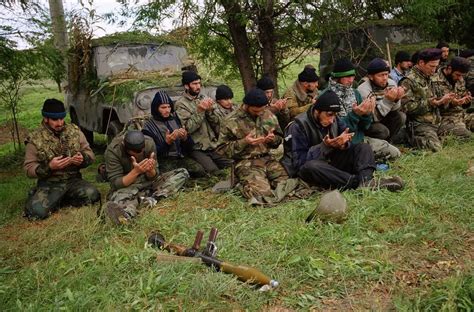 Chechen rebels praying before going off to the frontline to fight the advancing Russian army ...