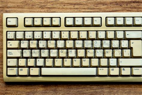 Old keyboard of a computer on a wooden ... | Stock image | Colourbox