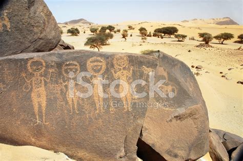 Ancient Rock Art In Sahara Depicting Four Figures Stock Photo | Royalty ...