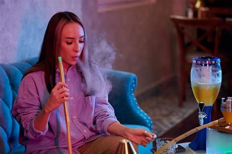 Premium Photo | Woman smoking hookah