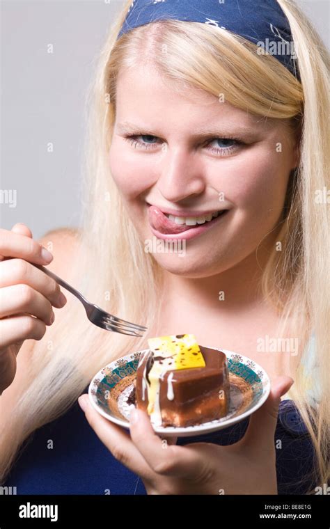 Fat young woman is eating cake Stock Photo - Alamy