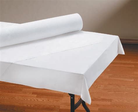 a roll of white paper sitting on top of a table next to a wooden floor