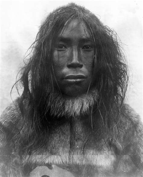 an old photo of a man with long hair and fur on it's face