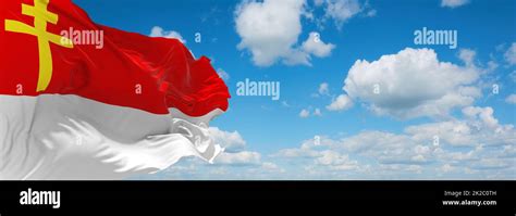 flag of Republic of Alsace Lorraine, Europe at cloudy sky background. flag representing extinct ...