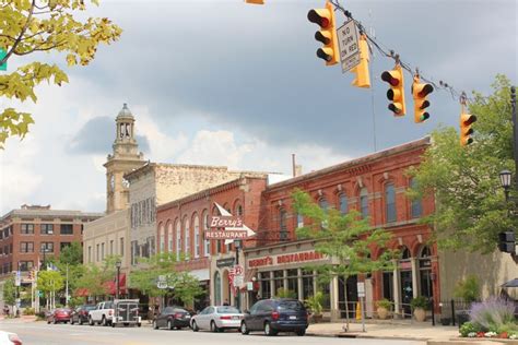 cars are parked on the street in front of buildings