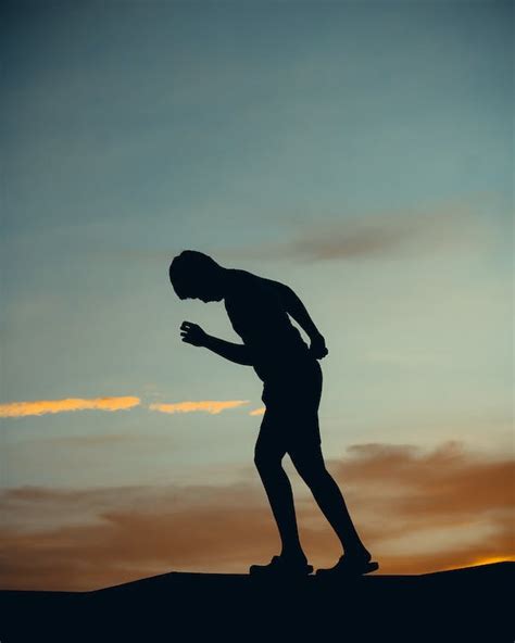 Silhouette of Man Walking During Sunset · Free Stock Photo