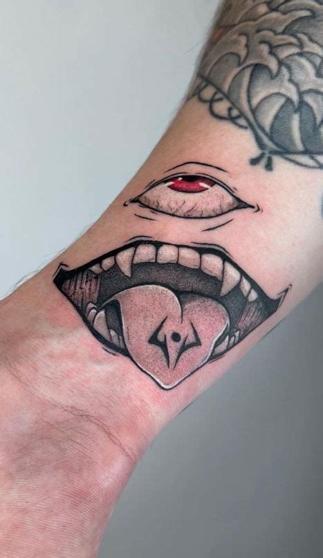 a person's hand with a tattoo on it and an open mouth in the middle