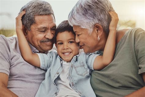 Premium Photo | Family portrait and child with grandparents in a living ...