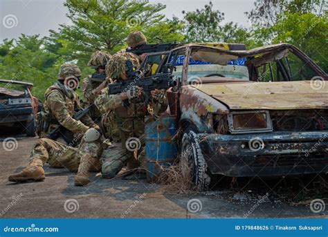 Special Forces Soldier in Combat Uniforms Aiming Gun Rifle To Attack ...