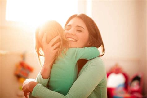 woman smiling and hugging child - Myhorizon