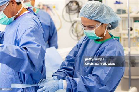 Surgical Assistant Helps A Surgeon Before Surgery High-Res Stock Photo ...