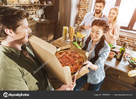 Young people eating pizza — Stock Photo © ArturVerkhovetskiy #150959974