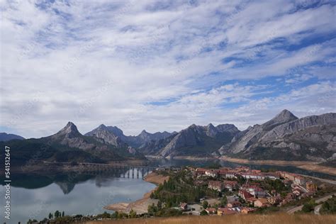 Spectaculars views of the town and the Riaño reservoir in front of the mountains on a cloudy day ...