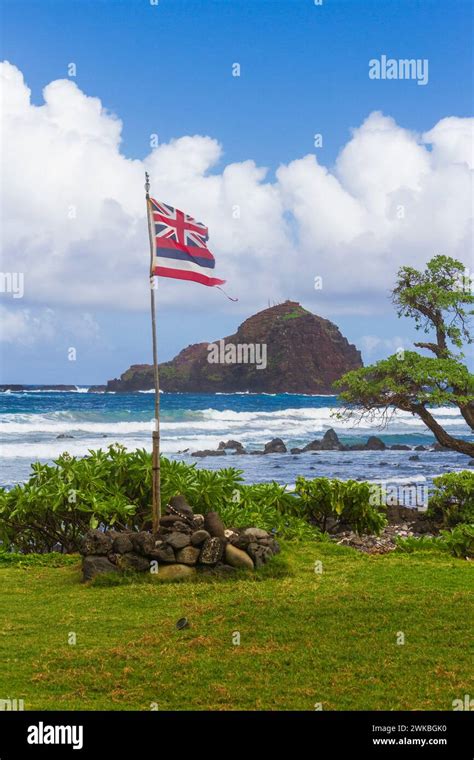 Hawaii Flag at Kaihalulu Red Sand Beach near the village of Hana on the ...